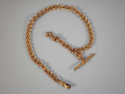 A yellow metal watch chain