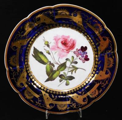 An early 19thC Derby porcelain blue mark armorial plate, within a gilt and floral border; c1800, a landscape plate with a duck egg border, with a similar gilt border and floral decorated plate with a blue and gilt border, c1835. (a quantity) - 7