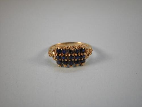 A gold ring set with fifteen sapphires