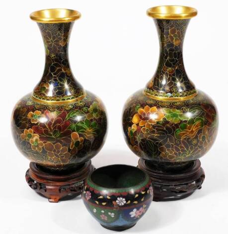 A pair of 20thC Chinese cloisonné vases, each of bulbous form with inverted trumpet stems, profusely decorated with flowers predominately in orange, green and blue, on circular feet, unmarked, 19cm H, with bases, etc. (a quantity)