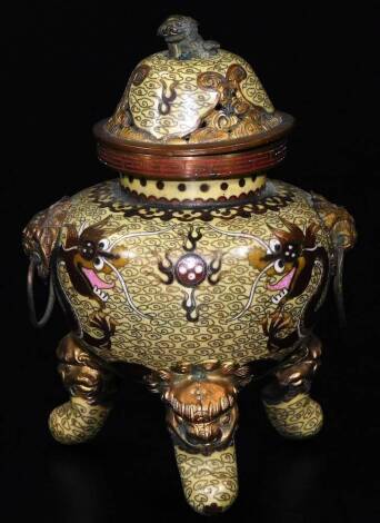 An early 20thC cloisonné lidded censer, with pierced domed lid, animal knop, dragon mask handles, shouldered circular body decorated with five claw dragon on a yellow ground terminating in triple shaped feet, 15cm H.