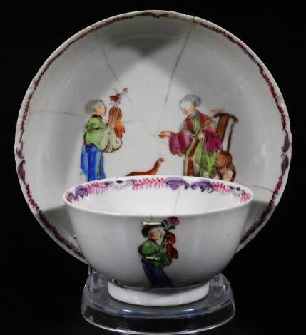 A Chinese Republic porcelain tea bowl and saucer, 13cm Dia. each polychrome decorated with figures and birds, predominately in pink, green and blue, unmarked. (AF)
