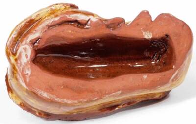 A glazed red ware pottery figure of a recumbent horned cow, in yellow and brown colour way, unmarked, 9cm W. - 4