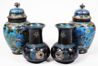 A pair of early 20thC Chinese cloisonné vases, each of shouldered circular form, decorated with flowers predominately in blue, green and white, with a further pair of cloisonné open vases with cylindrical stems and compressed domed bodies. (4)