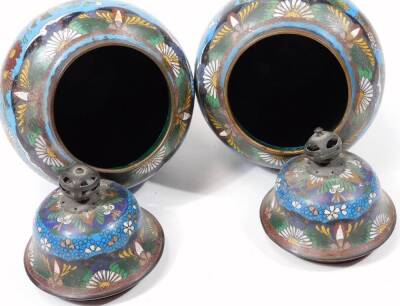 A pair of early 20thC Chinese cloisonné vases, each of shouldered circular form, decorated with flowers predominately in blue, green and white, with a further pair of cloisonné open vases with cylindrical stems and compressed domed bodies. (4) - 7