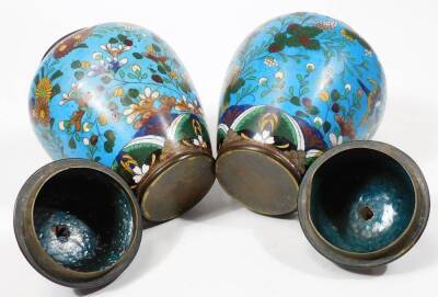 A pair of early 20thC Chinese cloisonné vases, each of shouldered circular form, decorated with flowers predominately in blue, green and white, with a further pair of cloisonné open vases with cylindrical stems and compressed domed bodies. (4) - 8