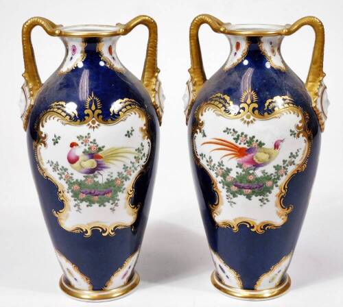 A pair of early 20thC Grainger & Co Worcester porcelain exotic bird pattern vases, each decorated with panels of birds and garlands, predominately in pink, yellow and green on blue grounds with gilt highlights, marked beneath, 23cm H.