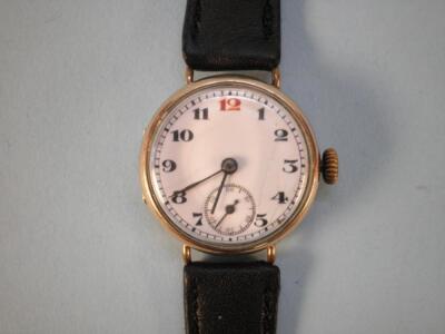 A yellow metal lady's wrist watch with a black strap