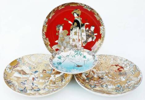 A pair of 19thC Japanese Meiji period Satsuma dishes, of circular form, profusely decorated with warriors, flowers, etc. with gilt highlights, 30cm Dia. and a pottery dish decorated with a geisha and a further florally decorated Japanese plate. (4)