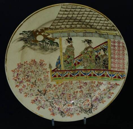 A 19thC Japanese Meiji period Satsuma pottery dish, Taizan seal mark, of circular form, decorated with a geisha in a pagoda with floral surround, with gilt rim, polychrome decorated, marked beneath, 30cm Dia.