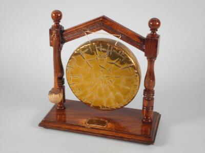 An Edwardian oak and brass dinner gong