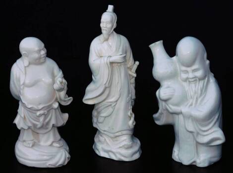 Various Chinese blanc de chine figures, comprising of a bearded sage in flowing robes, another holding enlarged pot and a figure of a Buddha holding orb, 21cm H, probably 20thC. (3)