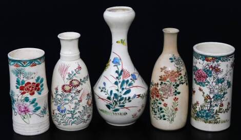 Various Japanese Meiji period pottery vases, each polychrome decorated, to include a double cylindrical example, with floral pattern and upper floral banding, predominately in pink and green, 13cm H, a garlic shaped vase of small proportion, with bellied 