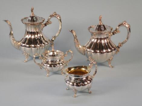 A four piece silver plated tea service with heraldic lion finials