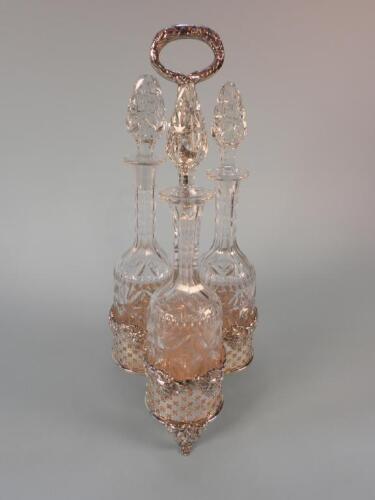 A silver plated decanter stand with pierced and line cast decoration