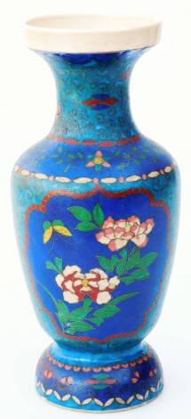 An early 20thC pottery cloisonné type vase, of shouldered form, profusely decorated with panels of flowers, predominately in blue, green and pink, on a domed circular foot, unmarked, 28cm H.