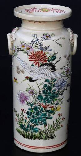 A Japanese pottery Kyoto type pottery vase, of turned form with moulded handles, the main body decorated with crane, butterfly and flowers, predominately in pink, green, yellow and red, with a double line lower banding and upper floral banding, signed, 2