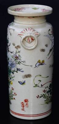 A Japanese pottery Kyoto type pottery vase, of turned form with moulded handles, the main body decorated with crane, butterfly and flowers, predominately in pink, green, yellow and red, with a double line lower banding and upper floral banding, signed, 2 - 2