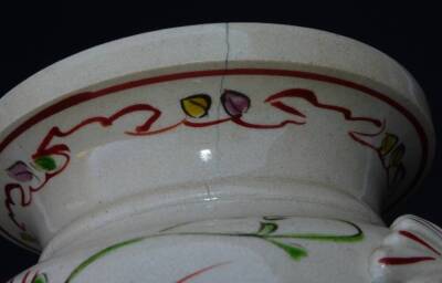 A Japanese pottery Kyoto type pottery vase, of turned form with moulded handles, the main body decorated with crane, butterfly and flowers, predominately in pink, green, yellow and red, with a double line lower banding and upper floral banding, signed, 2 - 7