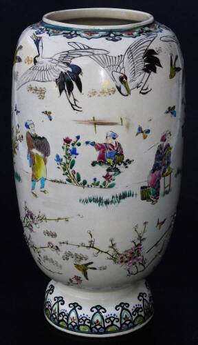 A Japanese Meiji period Kyoto type pottery vase, the shaped body decorated with crane, figures and flowers, predominately in orange, green and blue, with further insects beneath, on a circular domed foot, 30cm H.