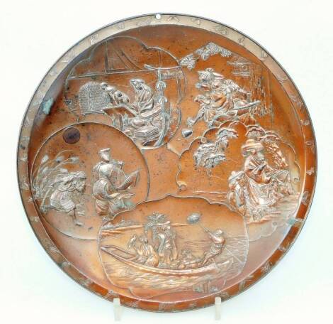 An early 20thC Japanese metal dish, of circular form raised with panels of figures with a brushed back set with seal mark, 25cm Dia.