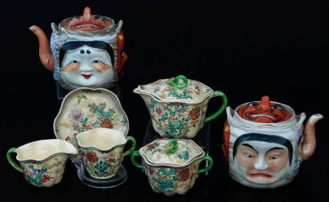 A 20thC Japanese grotesque teapot, set with figure lid, the body with further figures, with plain spout, polychrome decorated, 15cm H, a similar lidded vessel with shaped handle and various Kyoto type decorative items, lidded sugar bowl, jug, milk jug, et