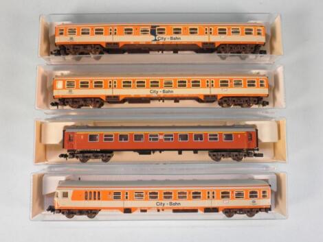 A set of three Fleischmann Piccolo N gauge coaches in orange and silver