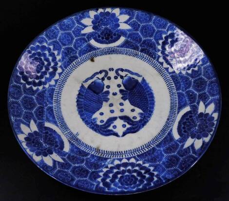 A Japanese porcelain Meiji style charger, of circular form, decorated with two fish to the centre with an outer floral banding, raised marks beneath, 47cm Dia.