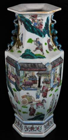 An 18thC style Chinese porcelain vase, of hexagonal form, profusely decorated with figures, set with an interior setting, exotic animals, etc. with moulded animal handles, famille rose decorated predominately in pink, turquoise and blue, with a lower flo