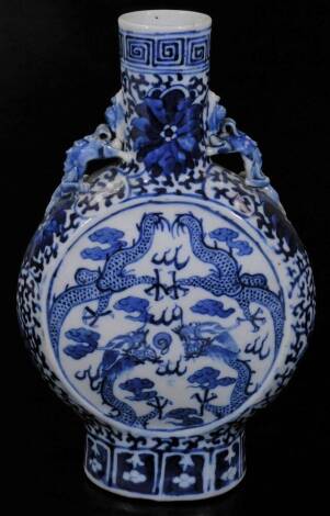 A 19thC Chinese blue and white porcelain moon flask, the circular body with dragon handles on oval foot with an upper Greek key style banding, 24cm H.