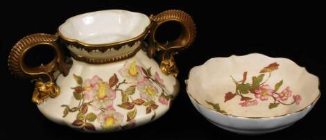 A late 19thC Royal Worcester porcelain two handled vase, of shaped form, with dragon handles, decorated with posies, with gilt highlights, marked beneath, 13cm H and a similar designed dish. (2)