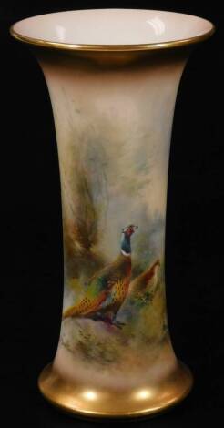 A 20thC Royal Worcester porcelain vase, by James Stinton, of trumpet shaped form, handpainted with pheasants in a naturalistic setting, with gilt highlights, signed JAS Stinton, marked beneath, 19cm H.