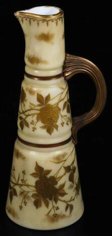 A 19thC blush ivory style glass ewer, of tapering circular form, gilt highlighted with flowers, with a shaped reeded handle, numbered W206 beneath, 24cm H.