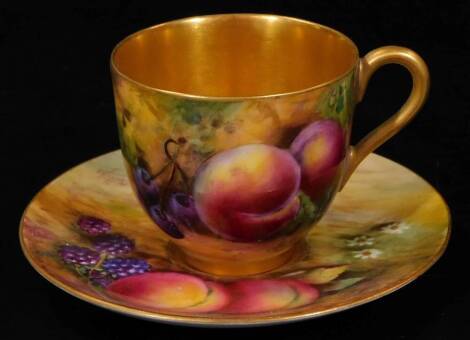 A 20thC Royal Worcester porcelain fruit pattern cup and saucer, 1921, by Harry Price, handpainted with autumnal fruits with gilt highlights, printed marks beneath, signed, the cup 4cm H.