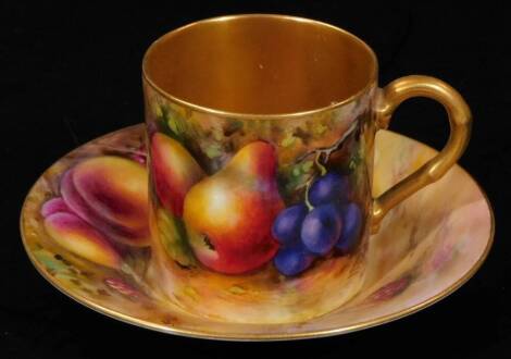 A 20thC Royal Worcester porcelain coffee can and saucer, 1924, by Harry Ayrton, handpainted with autumnal fruits, with gilt highlights, printed marks beneath, the coffee can 5cm H.