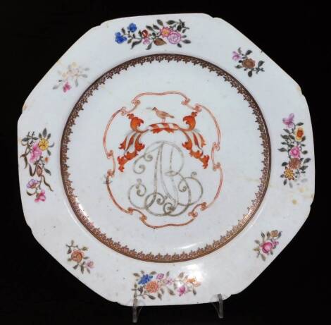 An 18thC Chinese export porcelain armorial plate, of octagonal form, polychrome decorated with flowers with a central initial and crest, polychrome decorated predominately in pink, green and orange, 22cm W and a further export porcelain armorial dish, ini