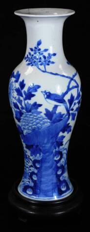 A 19thC Chinese Qing period porcelain vase, of inverted shouldered circular form, profusely decorated with birds and flowers, on a circular foot, four character mark beneath, 32cm H, on an associated stand. (AF)