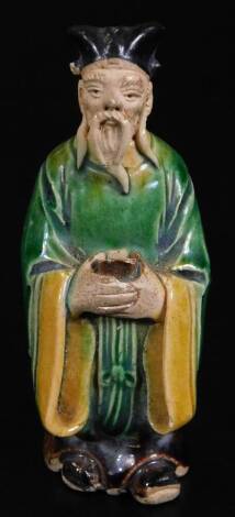 A Ming style terracotta grave figure of a warrior, dressed in finery, predominately in green, yellow and brown, unmarked, 10cm H.