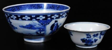 A Chinese porcelain tea bowl, of circular tapering form, decorated with flowers, with double line and floral interior, Kangxi style seal mark beneath, 8cm Dia. (AF) and a Chinese Qing period bowl decorated with panels of figures. (2)