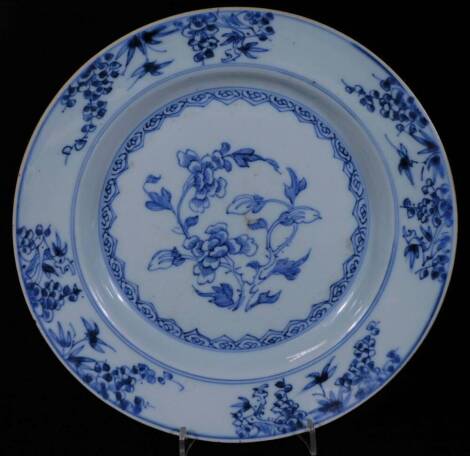 An 18thC Chinese porcelain plate, of circular form, profusely decorated with flowers, in blue and white, with a blue banding, 23cm Dia.