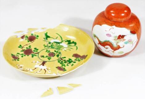 A Chinese porcelain famille jaune plate, of circular form, profusely decorated with trees in green, brown and white, blue six character Kangxi double line beneath, 24cm Dia. (AF) and a ginger jar and cover. (2)