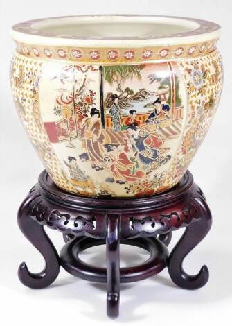 A late 20thC fish bowl, of tapering cylindrical form, decorated and raised by various figures broken by panels of flowers, with an upper floral banding and an interior of various fish, on a circular foot, pseudo mark beneath, on wooden stand, 36cm H, 26cm