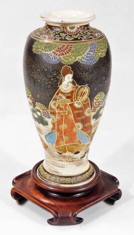 A large Japanese pottery vase, of shouldered tapering circular form, profusely decorated and raised with samurai and other figures, etc. predominantly in green, red and blue, on a black ground, with circular foot, marked beneath, probably late Meiji perio