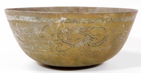 A Chinese metal bowl, profusely decorated with a banding of dragons, with an upper Greek key style border, seal mark beneath, 26cm Dia.