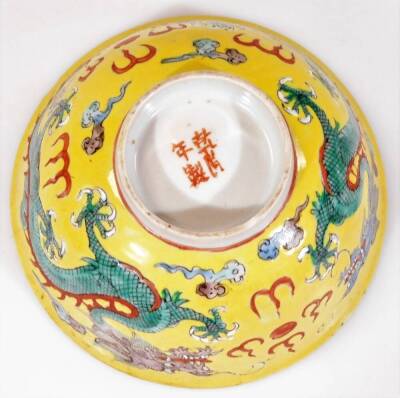 A Chinese pink enamel bowl of circular form, decorated with panels of flowers, 6cm H and a Chinese famille jaune bowl. (2) - 12