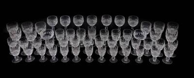 A Waterford cut glass part table suite decorated in the Colleen pattern, including red and white wine glasses, champagne cups, port and sherry glasses. (53)