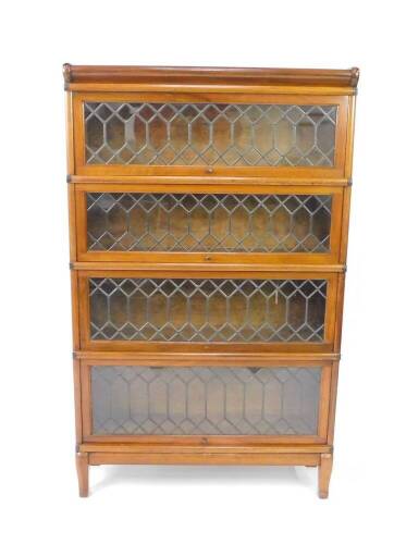 An early 20thC Globe Wernicke mahogany four section bookcase, with astragal glazed up and over doors, raised on cabriole legs, 141cm H, 86cm W, 27.6cm D.