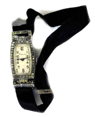 A Grosvenor ladies cocktail watch, with rectangular watch head, surrounded by marcasite set stones, on a silvered dial, white metal, unmarked but numbered 19984, on a black strap, 15.3g all in.