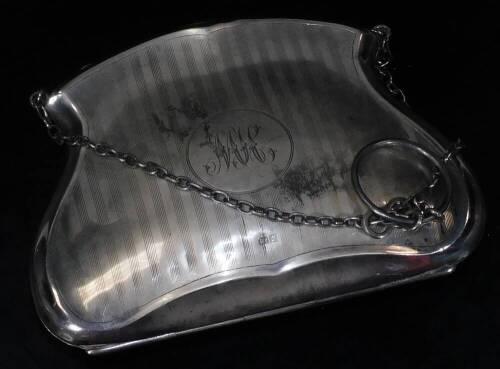 A George V silver evening purse, of shaped form with engine turned body and initialled cartouche with chain handle and fitted interior, 9cm H, 4oz all in.