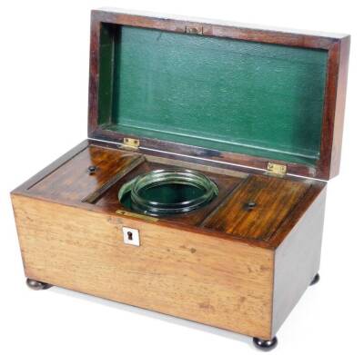 An early 19thC rosewood sarcophagus shaped tea caddy, of rectangular form, with a partially gadrooned lid, partially fitted interior centred by a removable mixing bowl, flanked by lidded compartments, on compressed bun feet, 16cm H, 28cm W, 16cm D. - 2